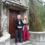 Nikita Kalashnikoff is in front of his childhood home with his wife, Solly, now the artistic director of the newborn art community in Chisinau.