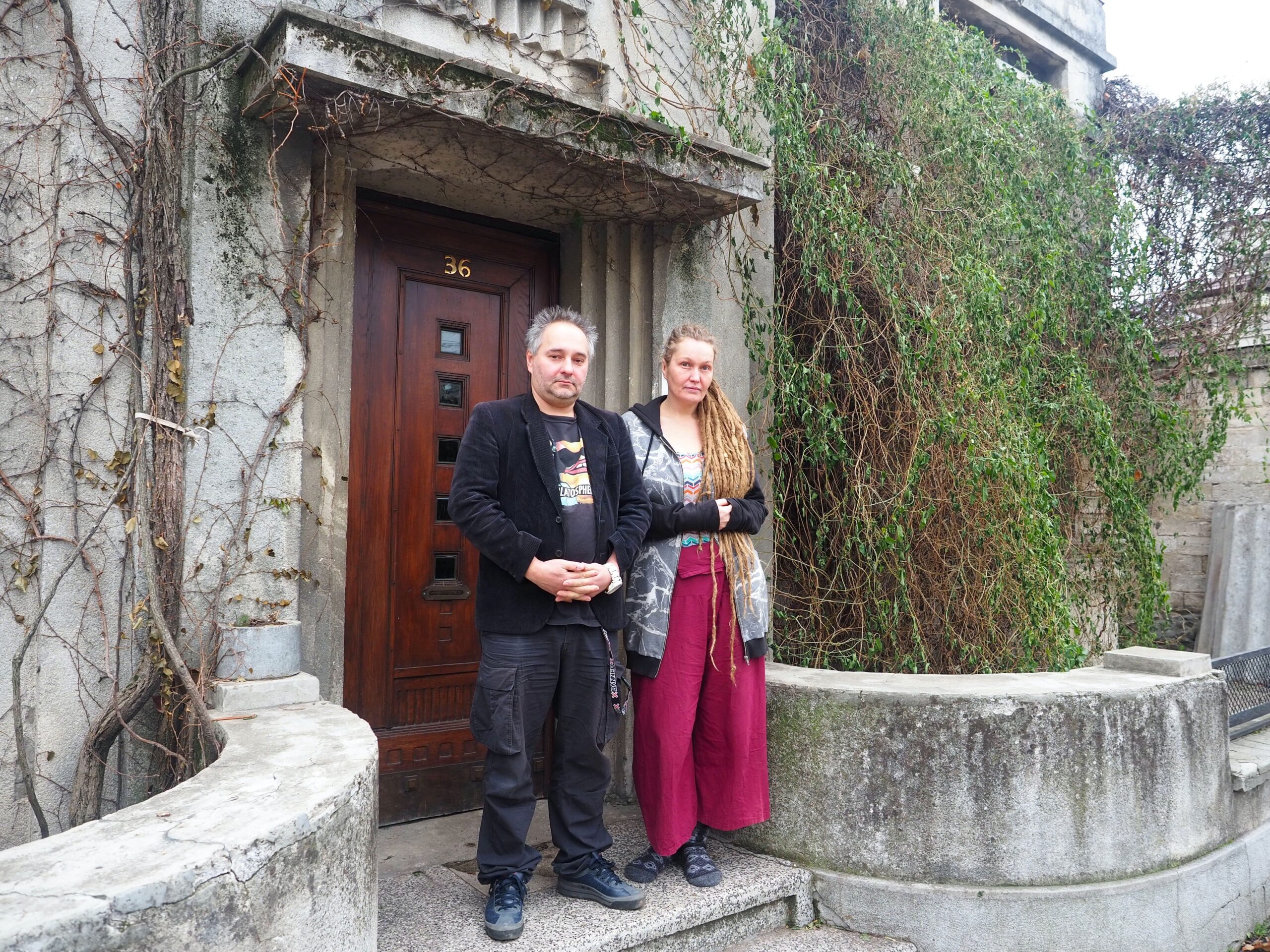 Nikita Kalashnikoff is in front of his childhood home with his wife, Solly, now the artistic director of the newborn art community in Chisinau.