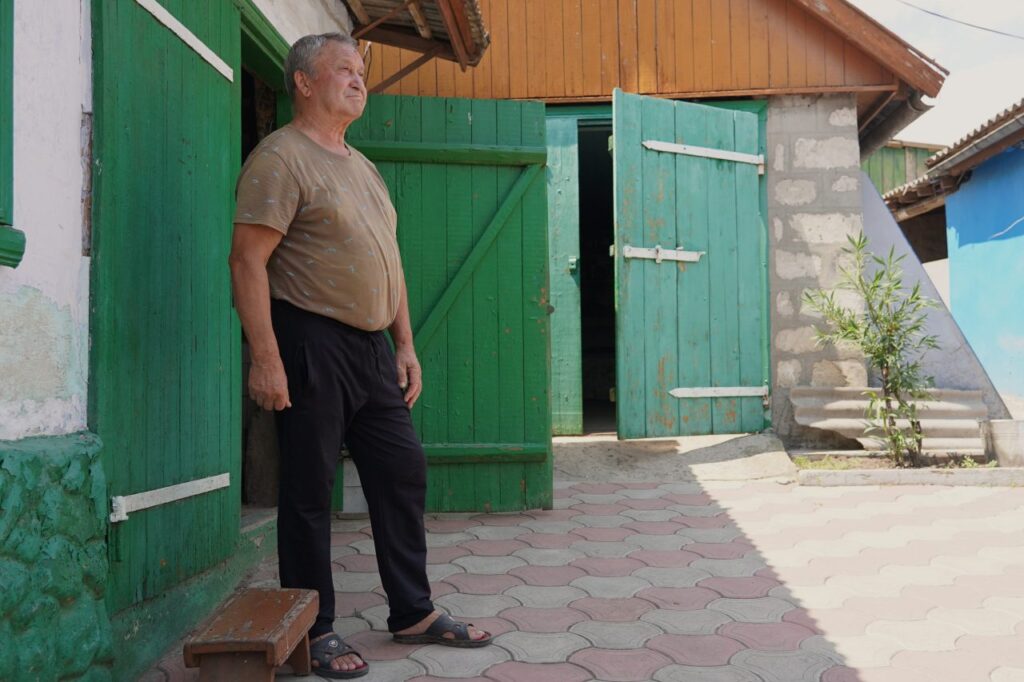 Vadim, a pensioner and a widow, in his courtyard.